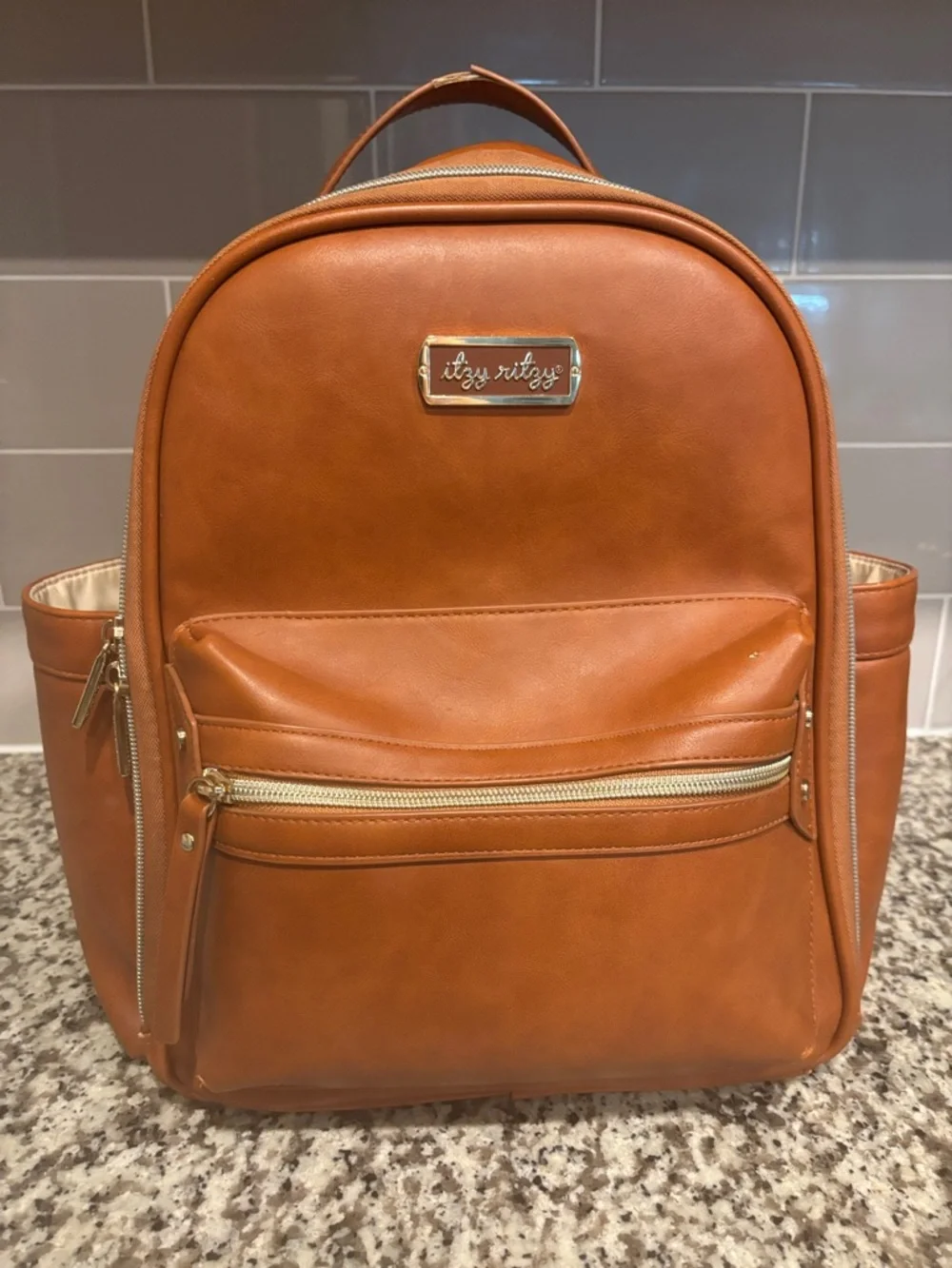 Itzy Ritzy Men's Cognac/Tan Faux Leather Backpack with Gold Hardware